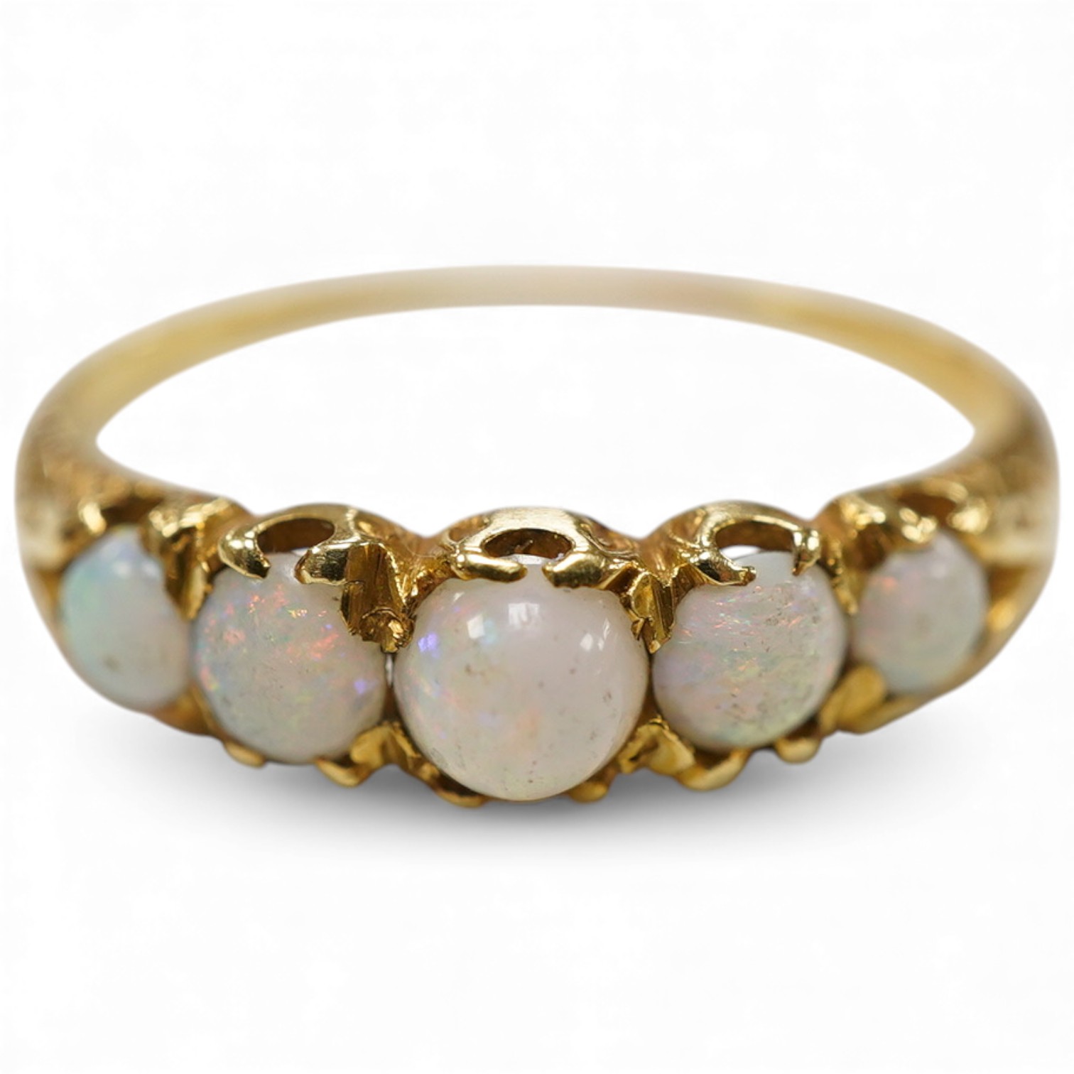 A late Victorian yellow metal and five stone graduated white opal set half hoop ring, the inner shank engraved 'Bran? Ap 4.89', size L.